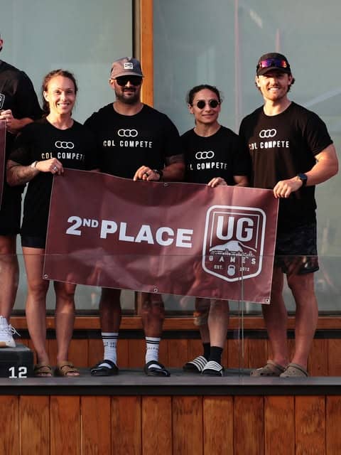 Bar None members holding a second place banner at a team competition